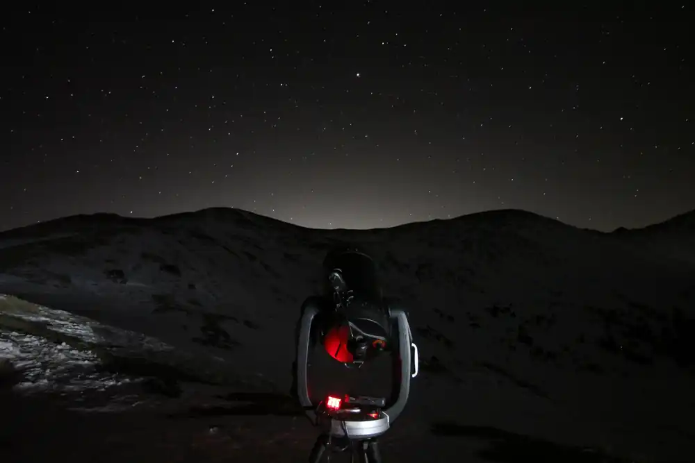 A telescope set up under a star-filled sky on Loveland Pass in Colorado.